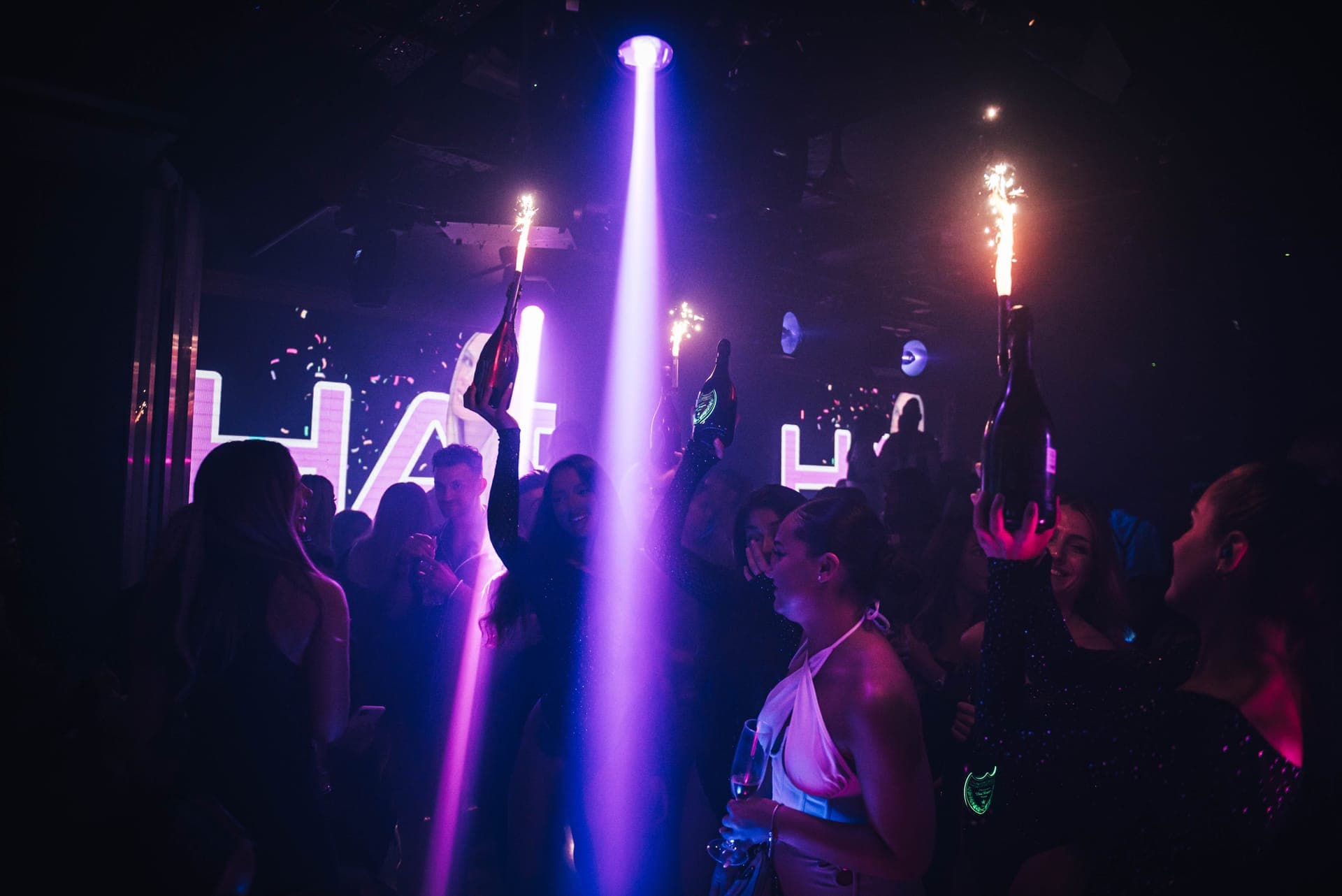 VIP nightclub interior with bottle service and ambient lighting