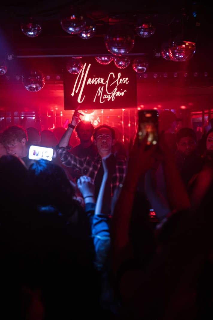 Drinks and water served at a busy London nightclub bar at night