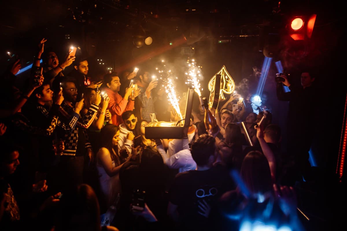 VIP table at a London nightclub with bottle service and sparklers