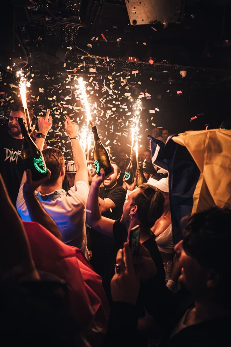 Group of friends seated at a VIP table in a Mayfair nightclub
