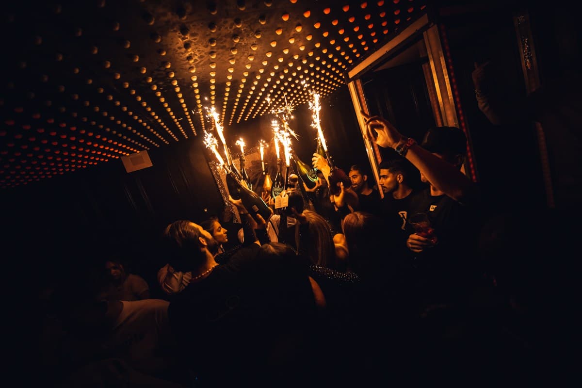 Reserved VIP table at a Mayfair nightclub with bottle service and ambient club lighting