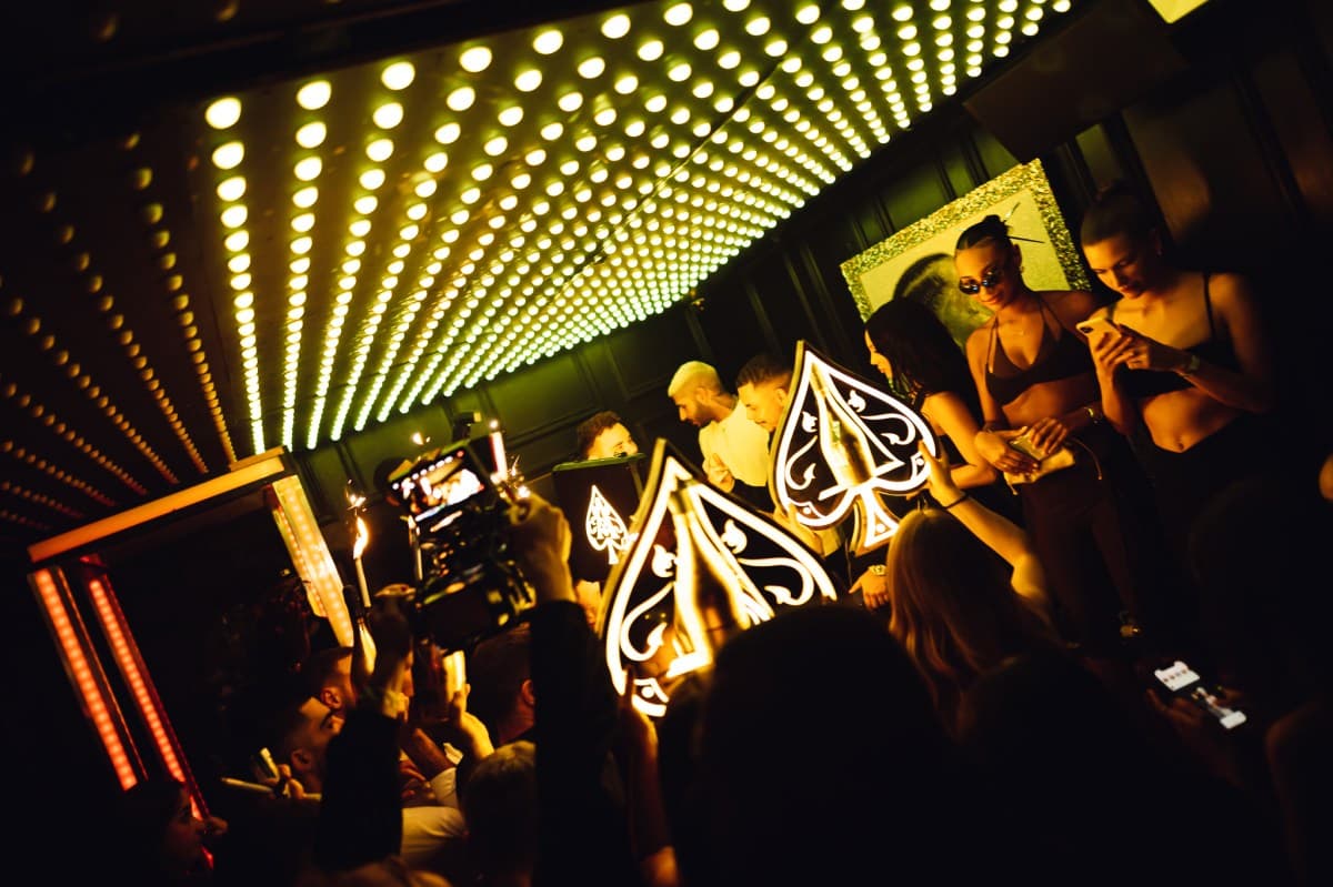 Stylishly dressed guests arriving at a London nightclub