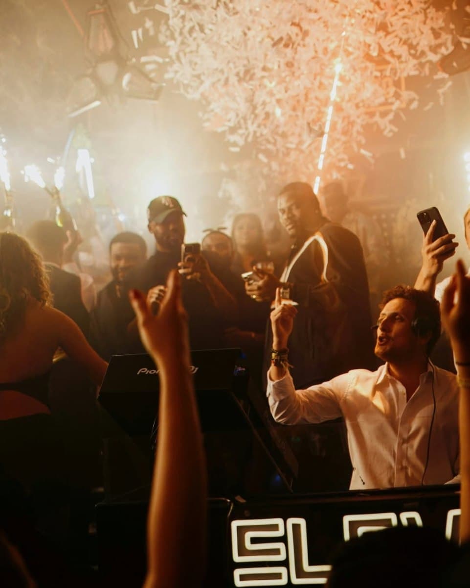 London Reign showclub interior with stage lighting and VIP table areas