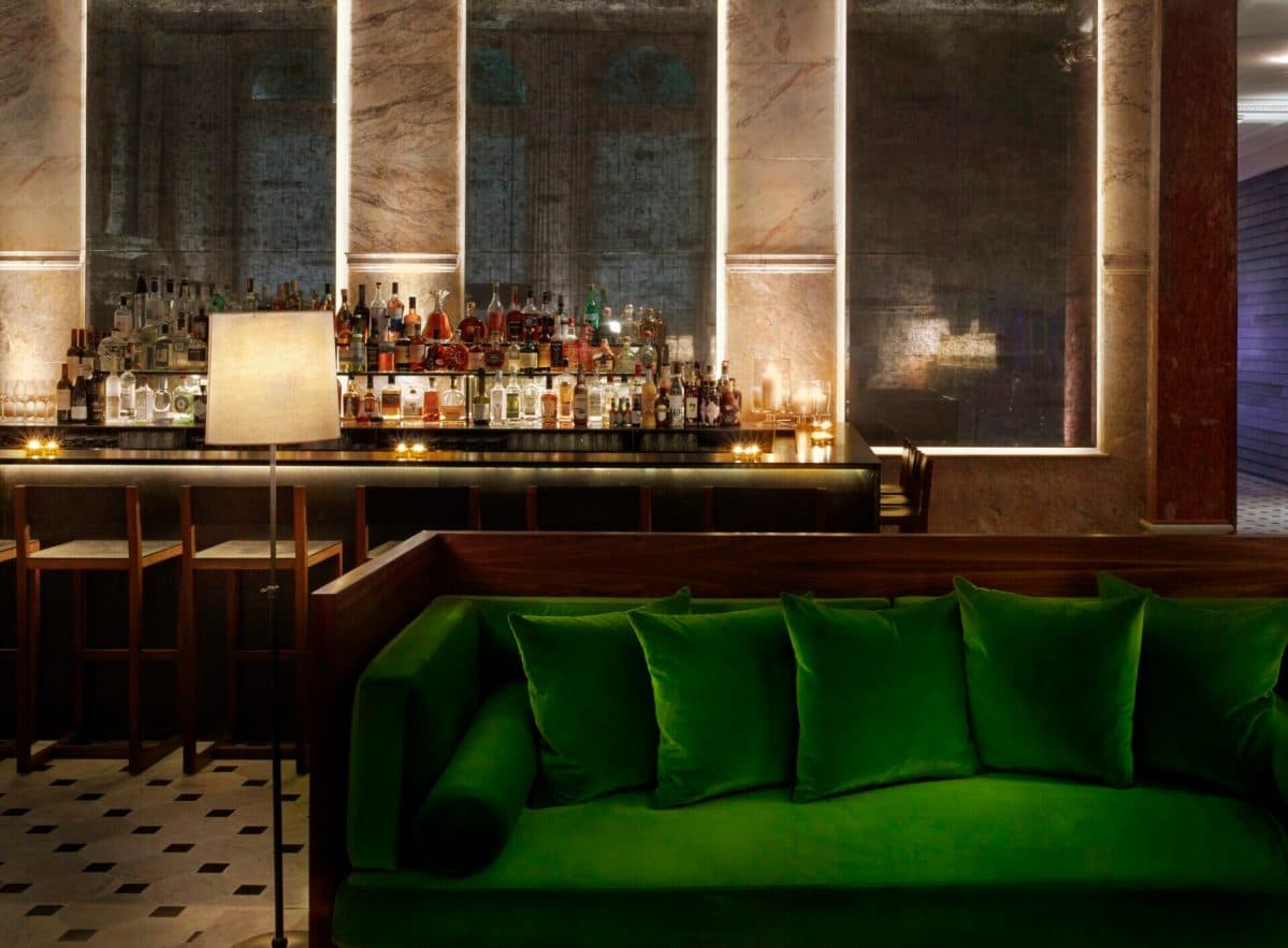 Stylish Soho hotel bar with ambient lighting, craft cocktails, and a lively pre-drinks atmosphere