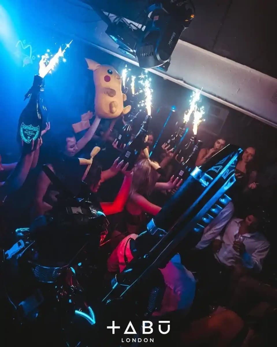 Tabu nightclub London VIP table area with bottle service and neon decor