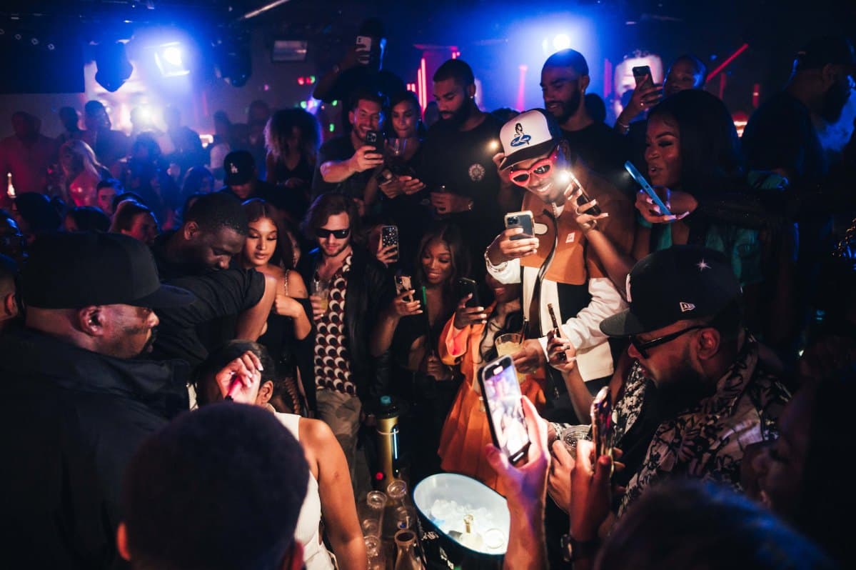 VIP table with bottle service next to a busy dancefloor in a London nightclub