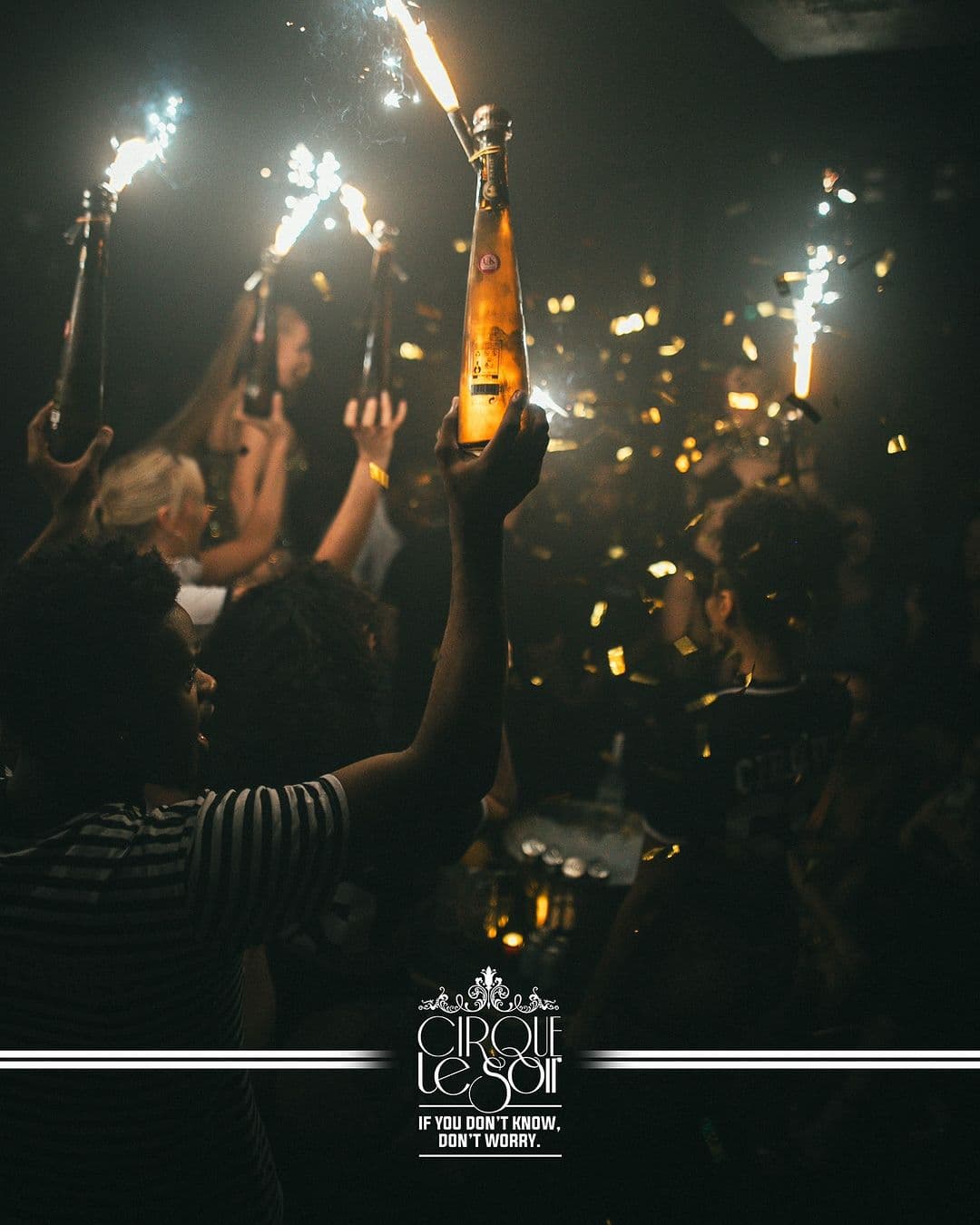 Cirque Le Soir performer on stage dressed as a dinosaur