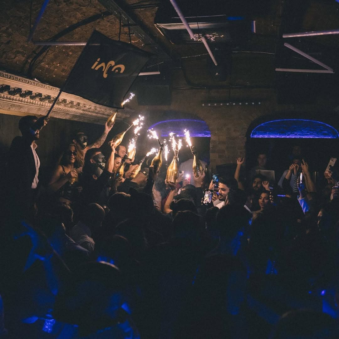 Luna London guestlist client drinking a shot in the club